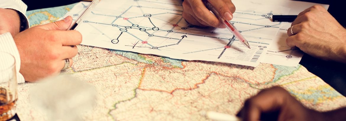A travel consultant and client reviewing a route map together while planning an itinerary